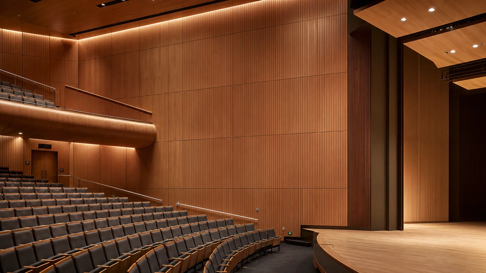 Performing arts auditorium with flush grooved wood acoustic panel surfaces