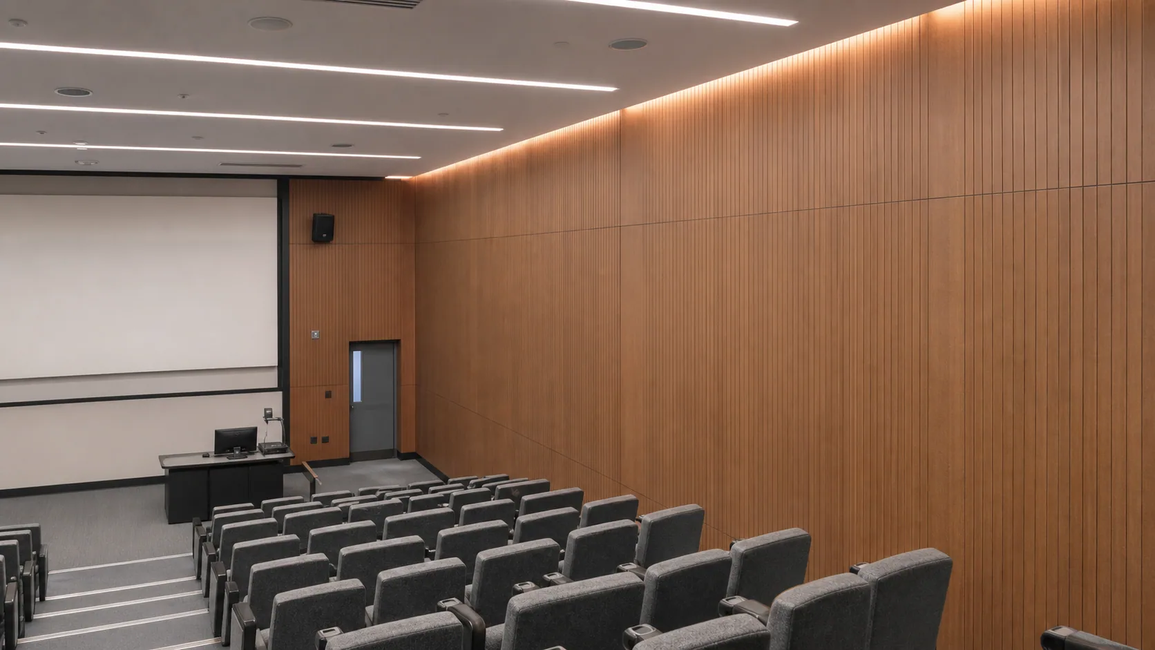 University lecture hall lined with flush grooved wood acoustic panels