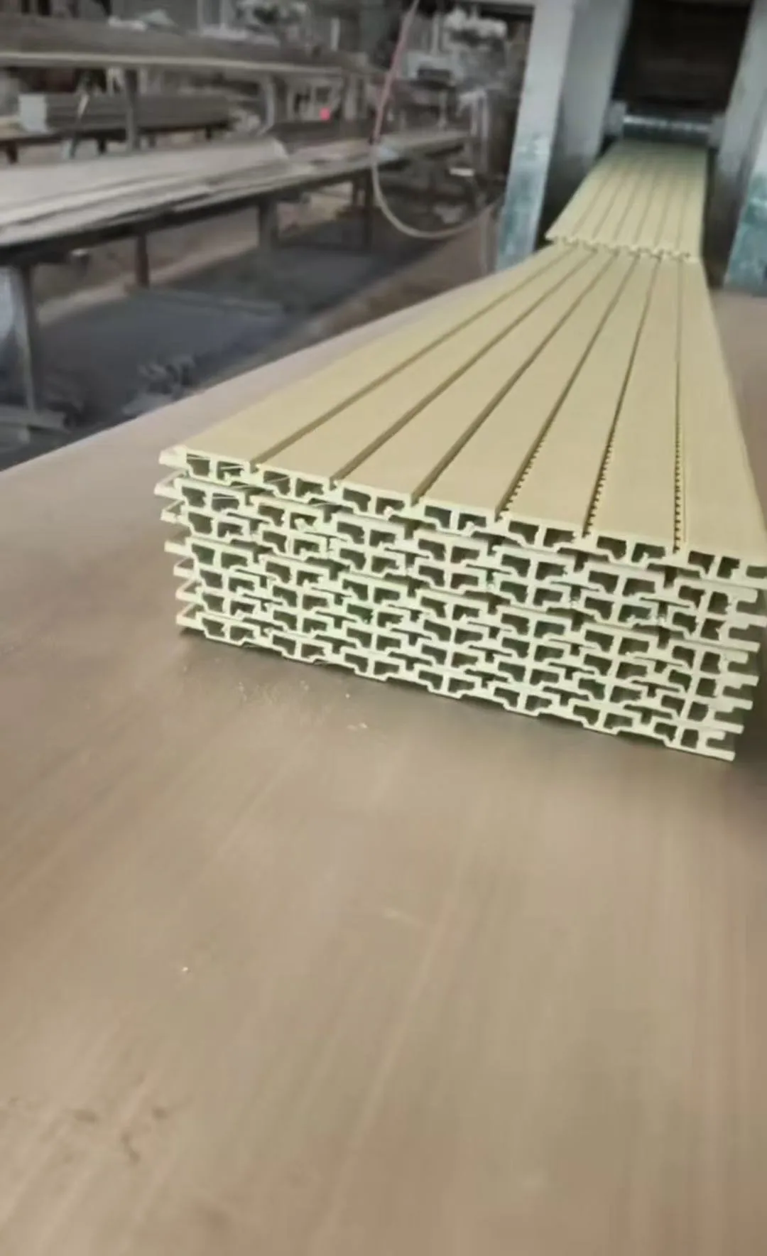 Stacked light-coloured factory profiles on a work surface